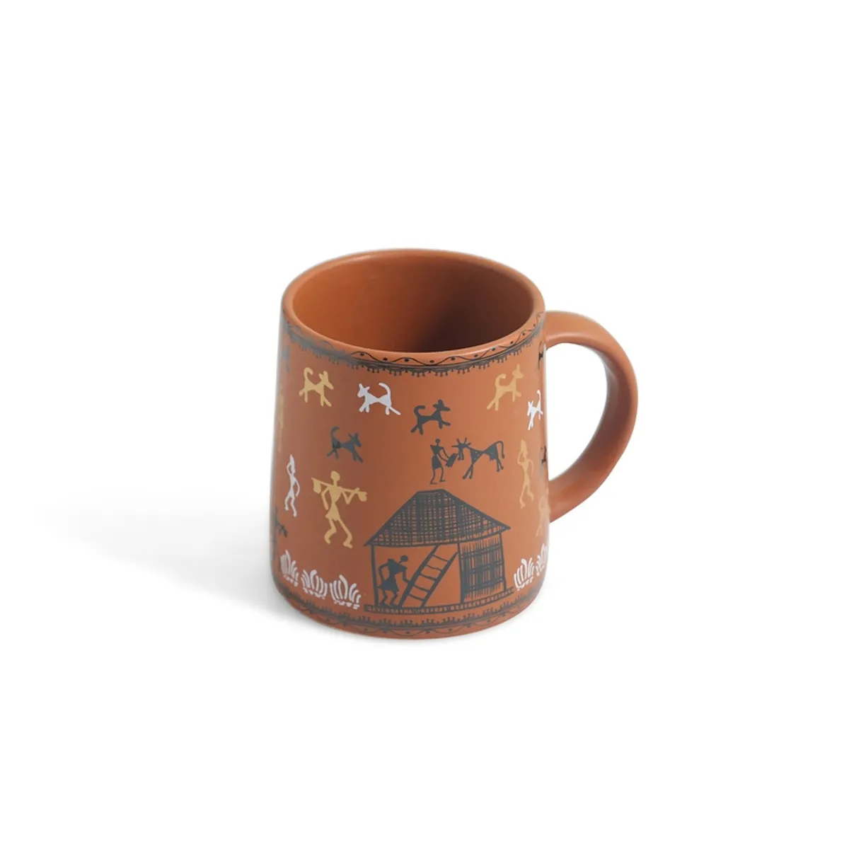 Single brown ceramic mug with Warli figures and a house motif on a white background.