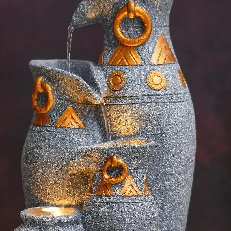 Detailed view of the upper pitcher forms with flowing water and gold accents.