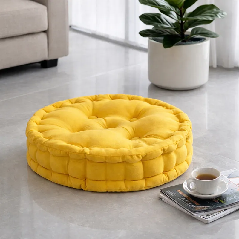 Round mustard yellow floor cushion styled on a living room floor