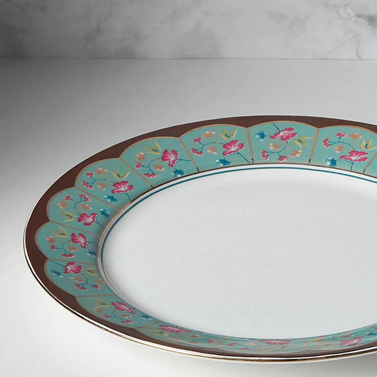 Close-up of the plate's colourful floral rim and white centre.