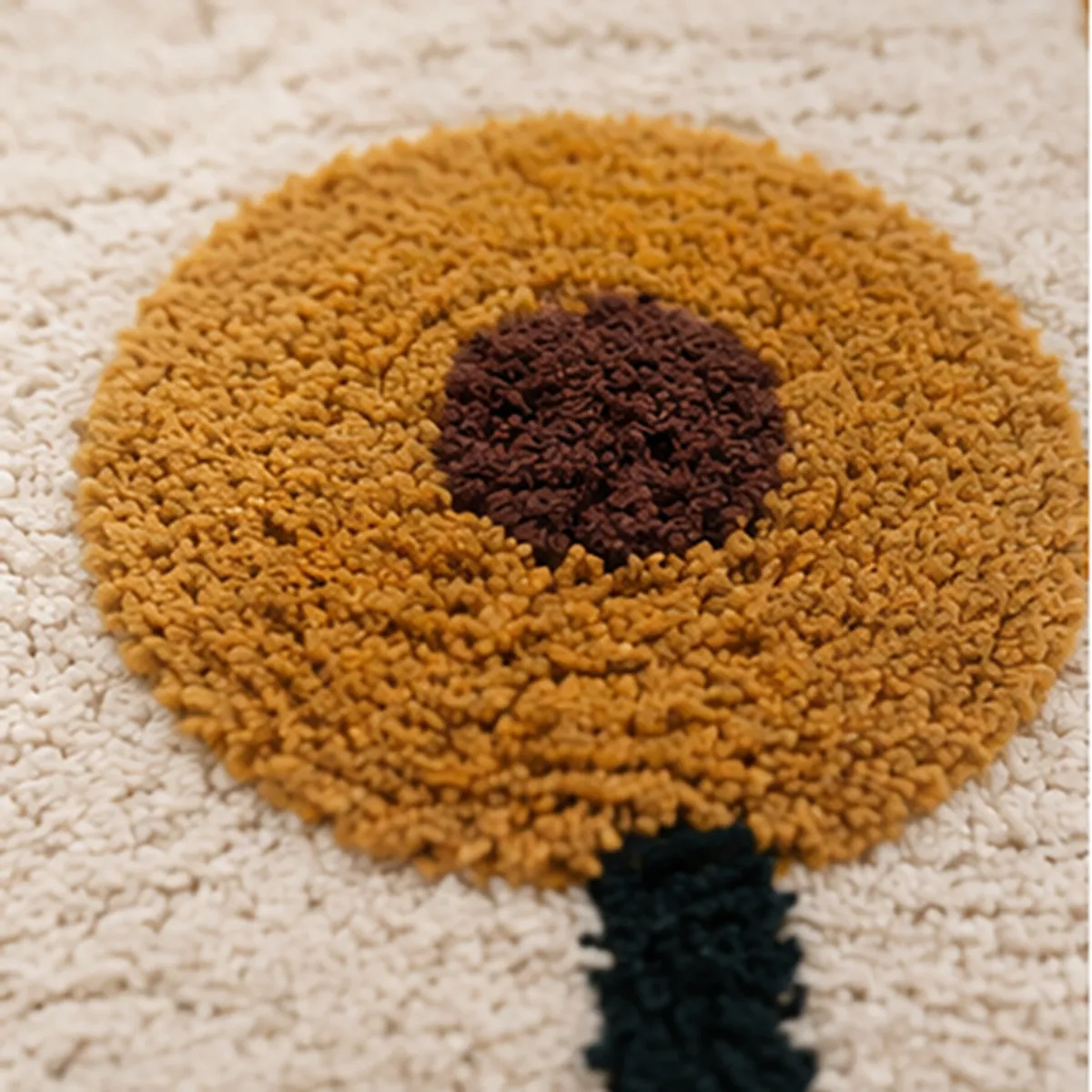 Close-up view of a yellow flower motif with a brown centre on the bath mat