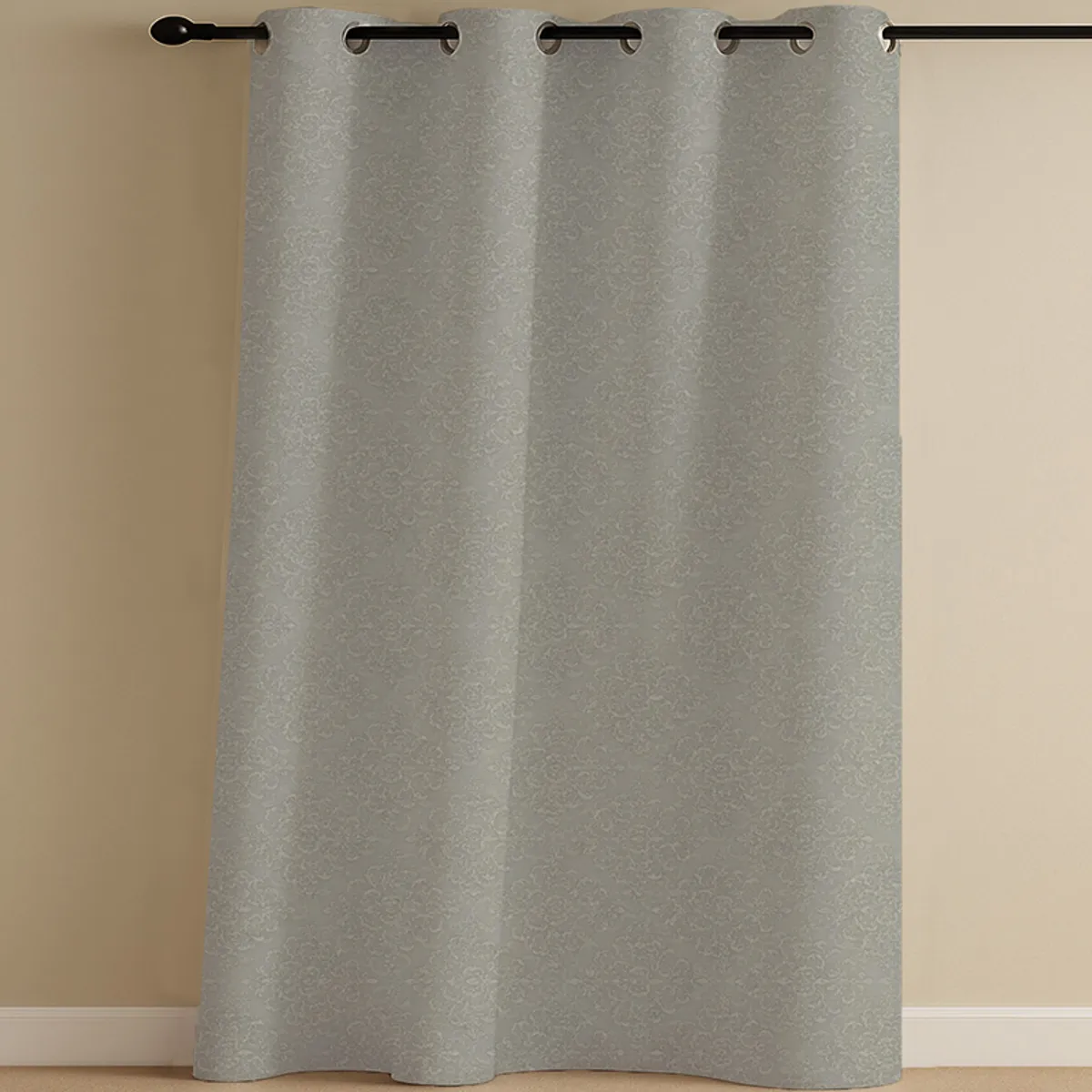 Grey patterned eyelet curtain hanging on a black curtain rod