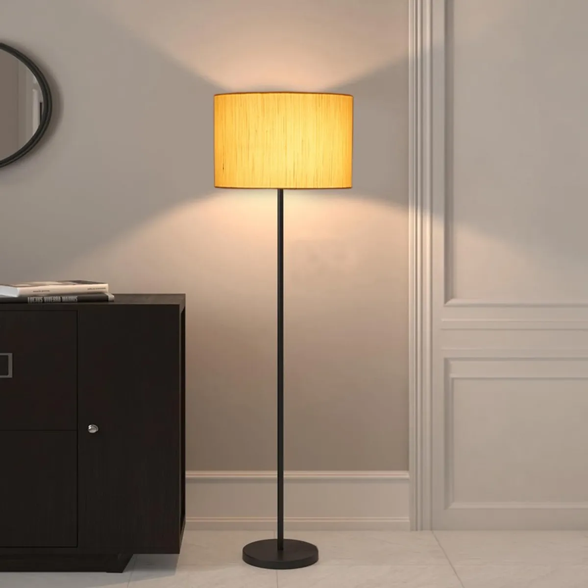 Lit ivory drum floor lamp beside a dark cabinet against a plain wall