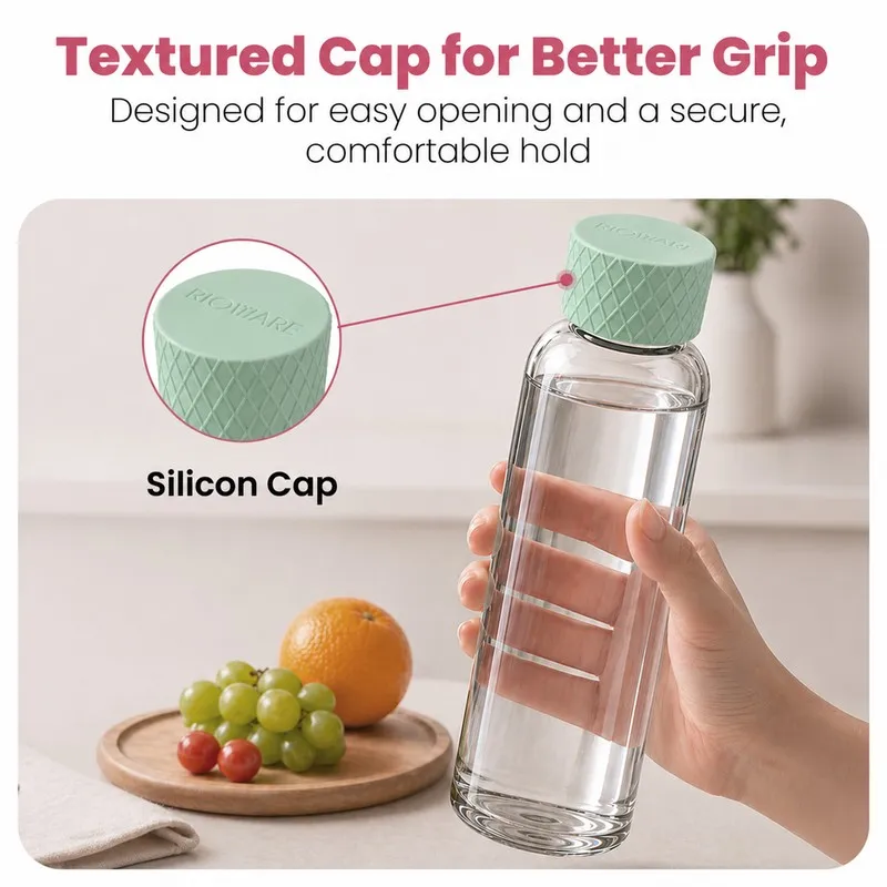 Hand holding a transparent glass bottle with a green textured cap.