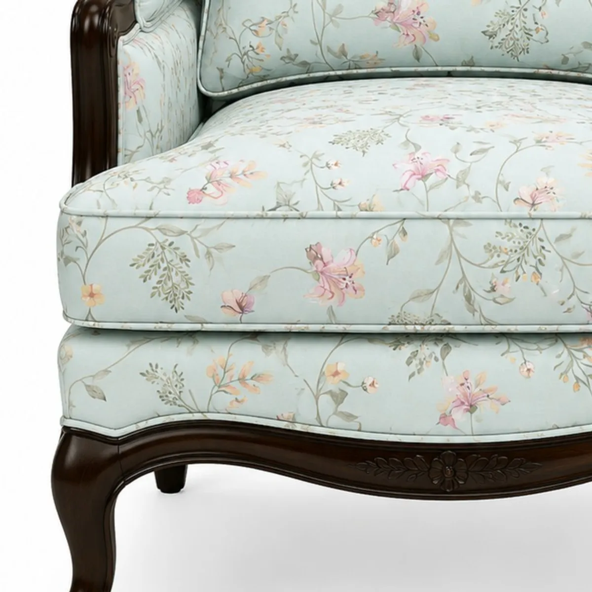 Close-up of pale blue floral upholstery and dark glossy wood frame detail