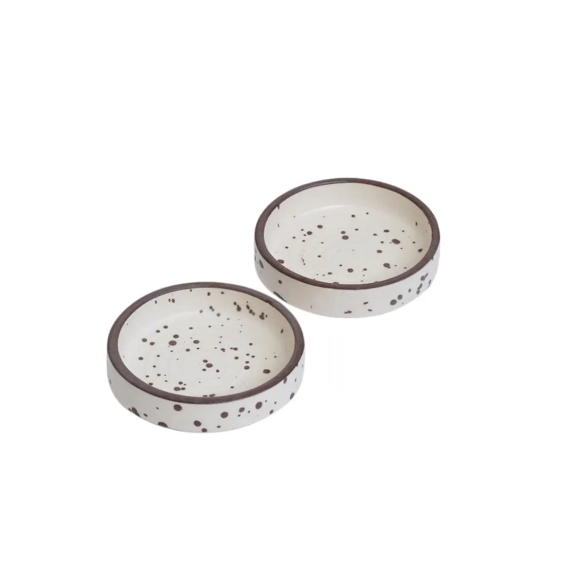 Two round speckled white ceramic dip bowls on a white background