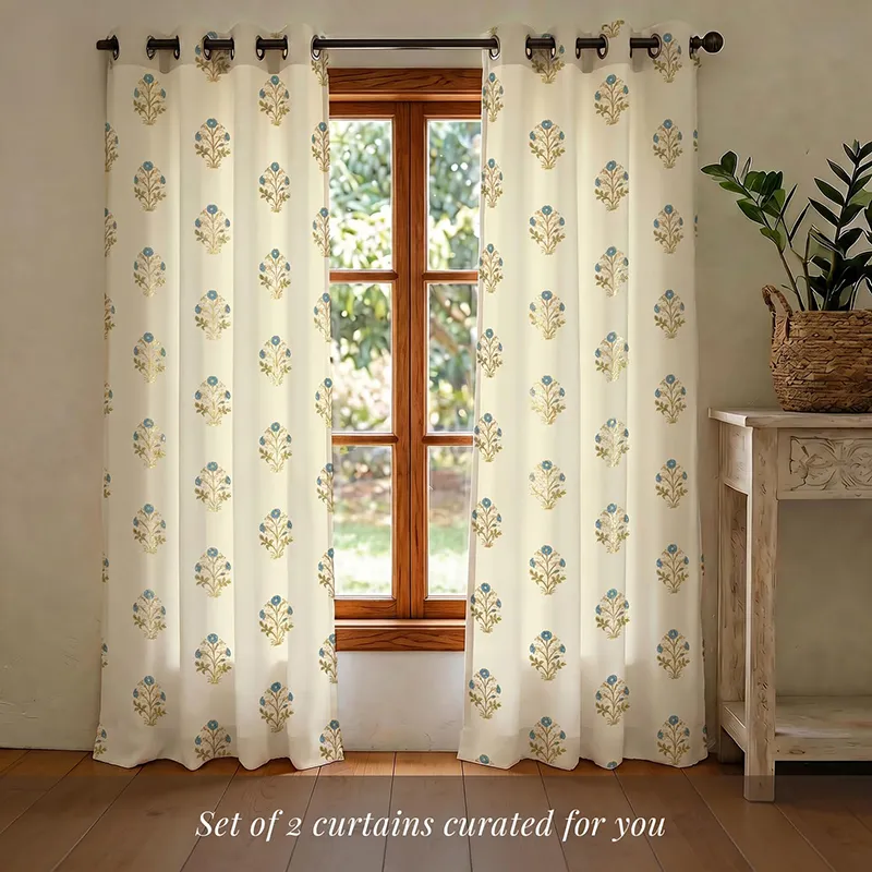Set of floral foil printed curtains hanging on a window rod
