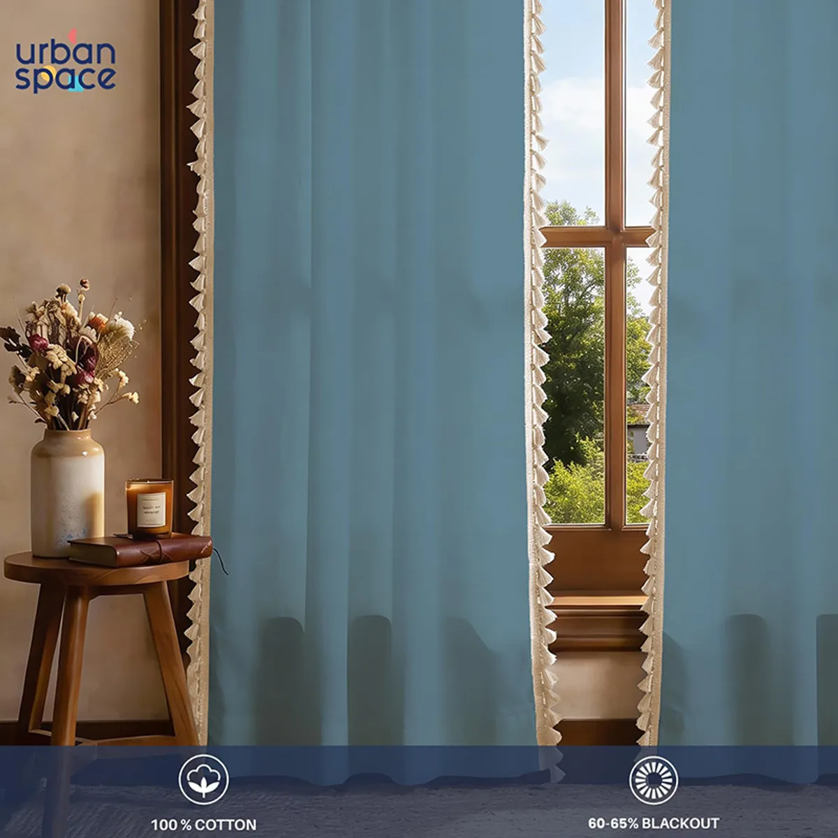 Close view of blue curtain panels with cream tasselled edges beside a window