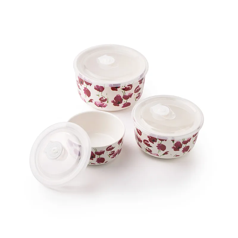 Three pink floral porcelain containers with transparent lids shown against a white background