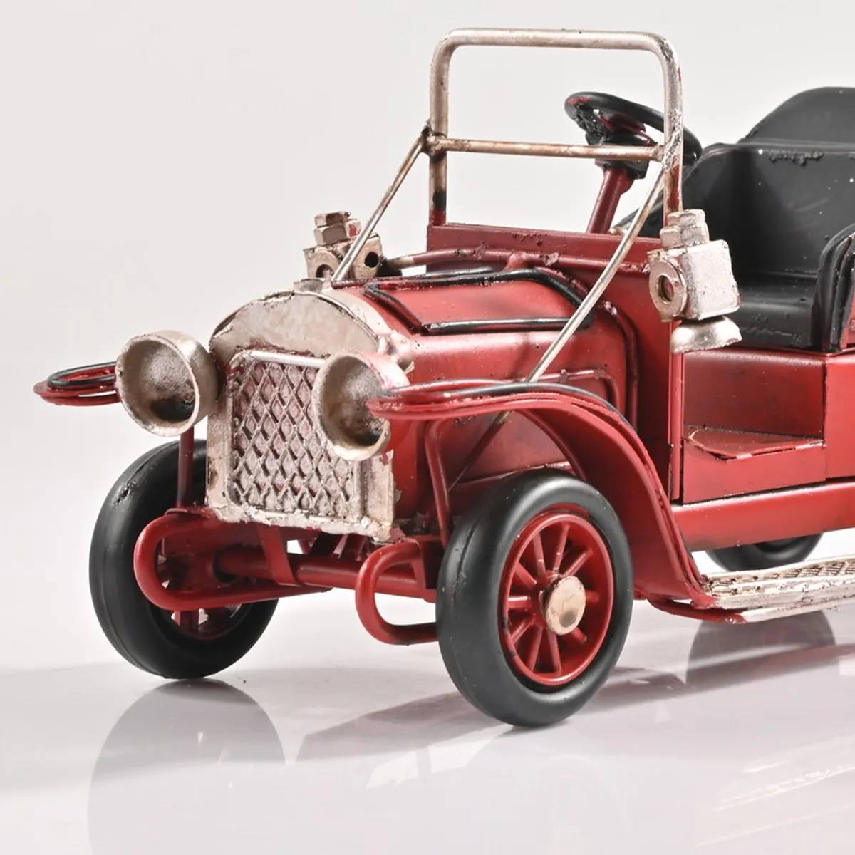 Close-up of the front detailing on the red vintage car showpiece