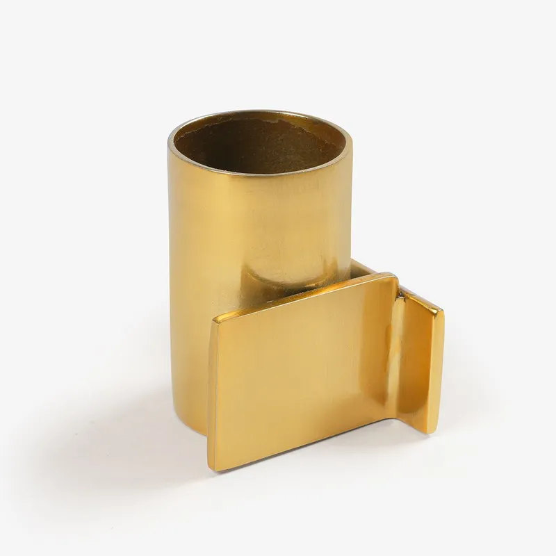 Gold candle holder with cylindrical form and angular side plate