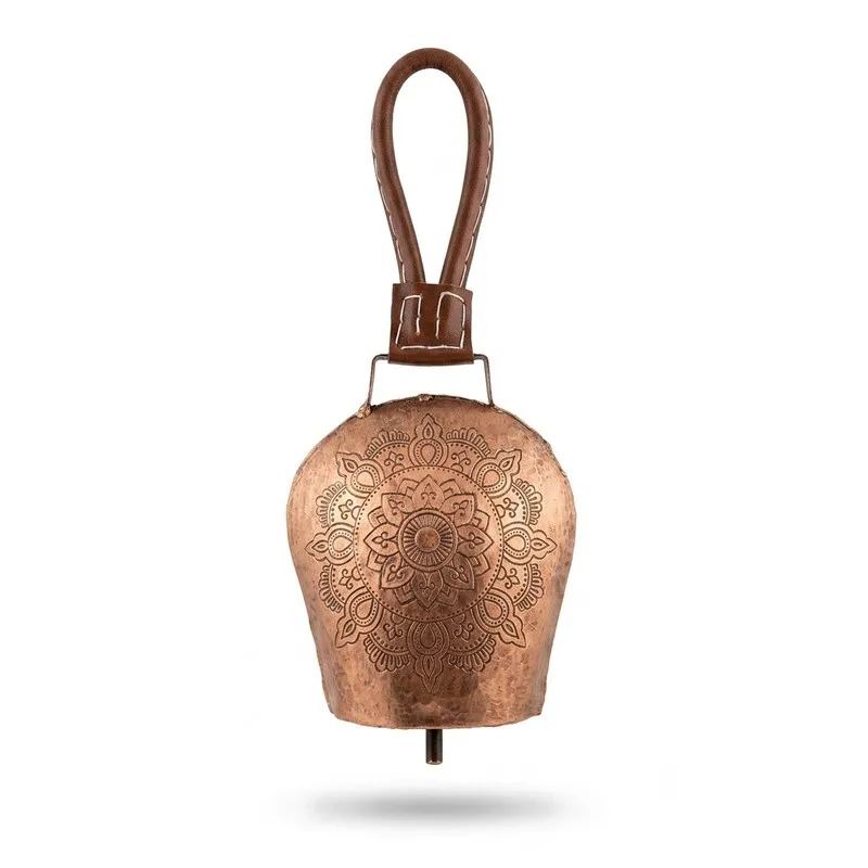 Front view of copper-toned metal hanging bell with mandala engraving and leather loop
