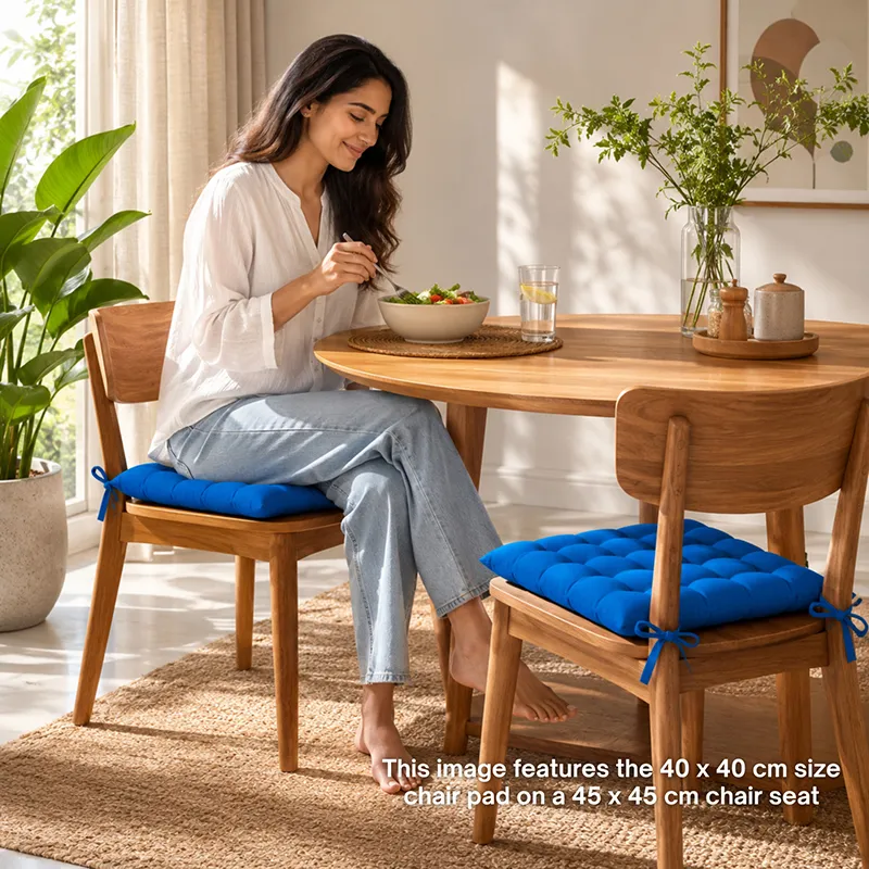 Blue chair pads styled on wooden dining chairs in a bright dining space.