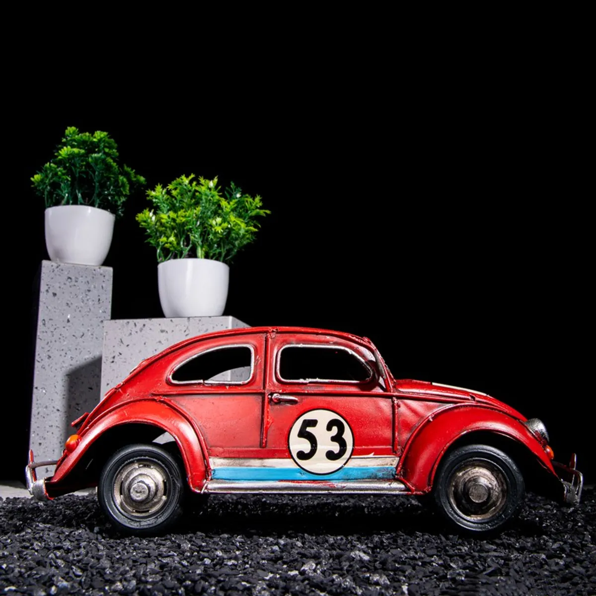 Side view of a red vintage racing car iron showpiece