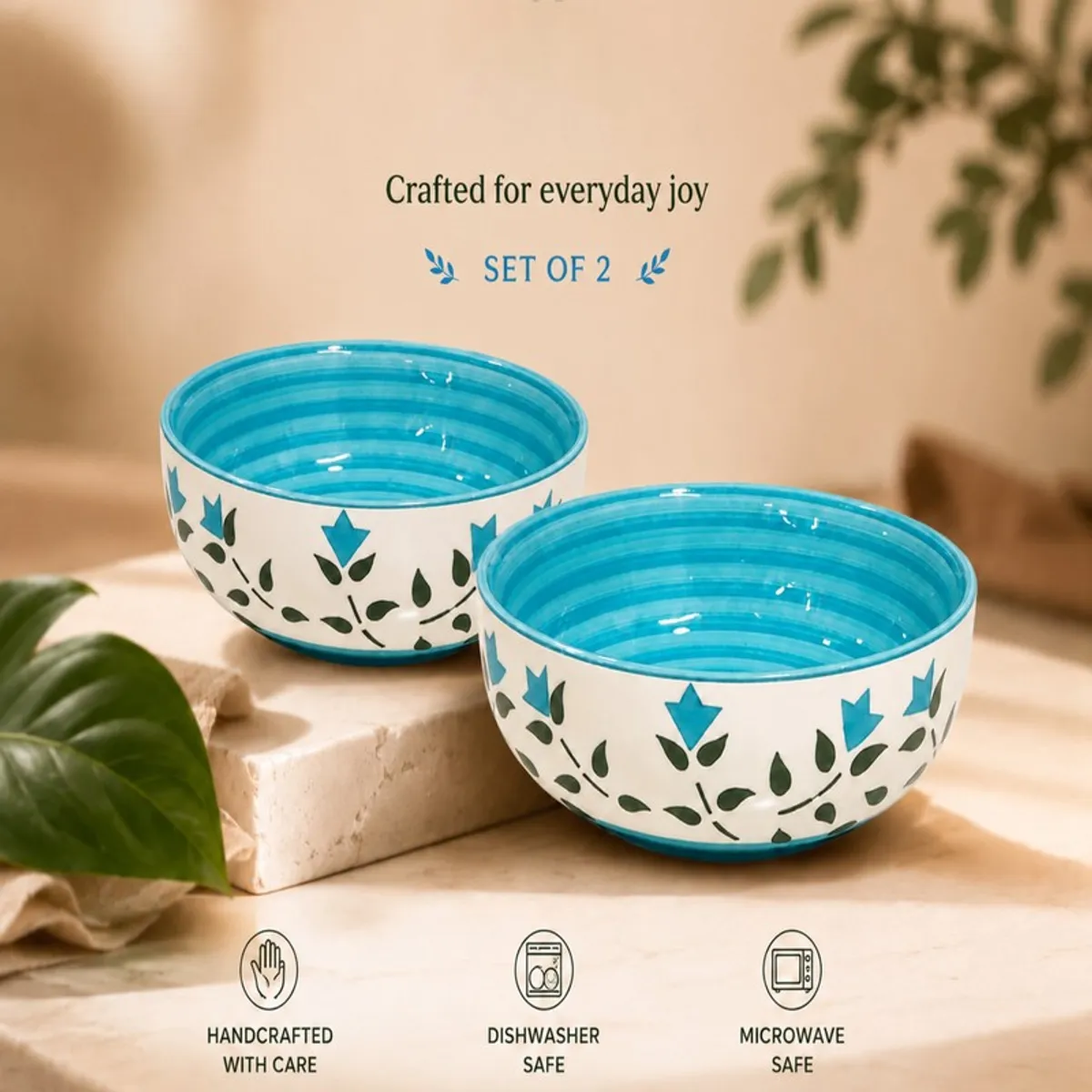 Two blue and white floral bowls styled in a warm dining setting