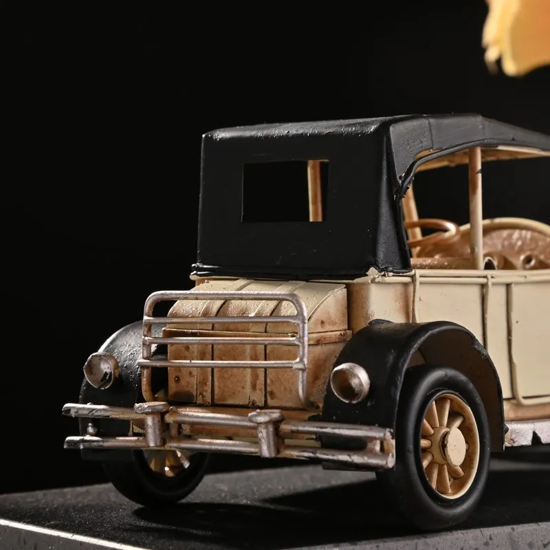 Rear angle close-up of the beige vintage model car showpiece