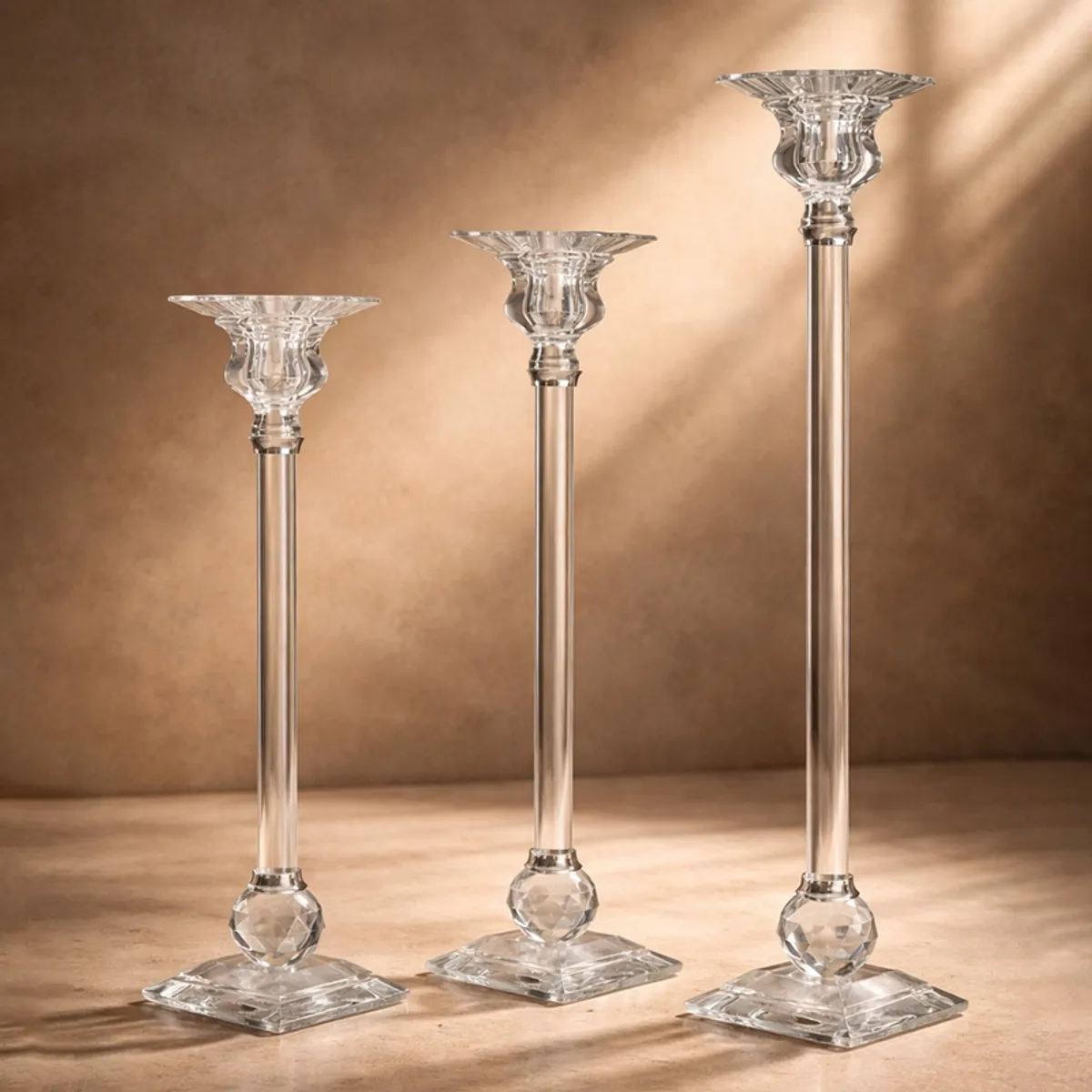 Three clear crystal candle holders arranged on a living room table