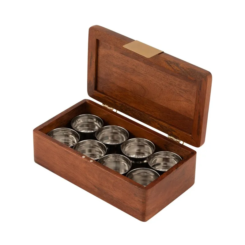 Open brown wooden masala box displaying multiple metal spice bowls