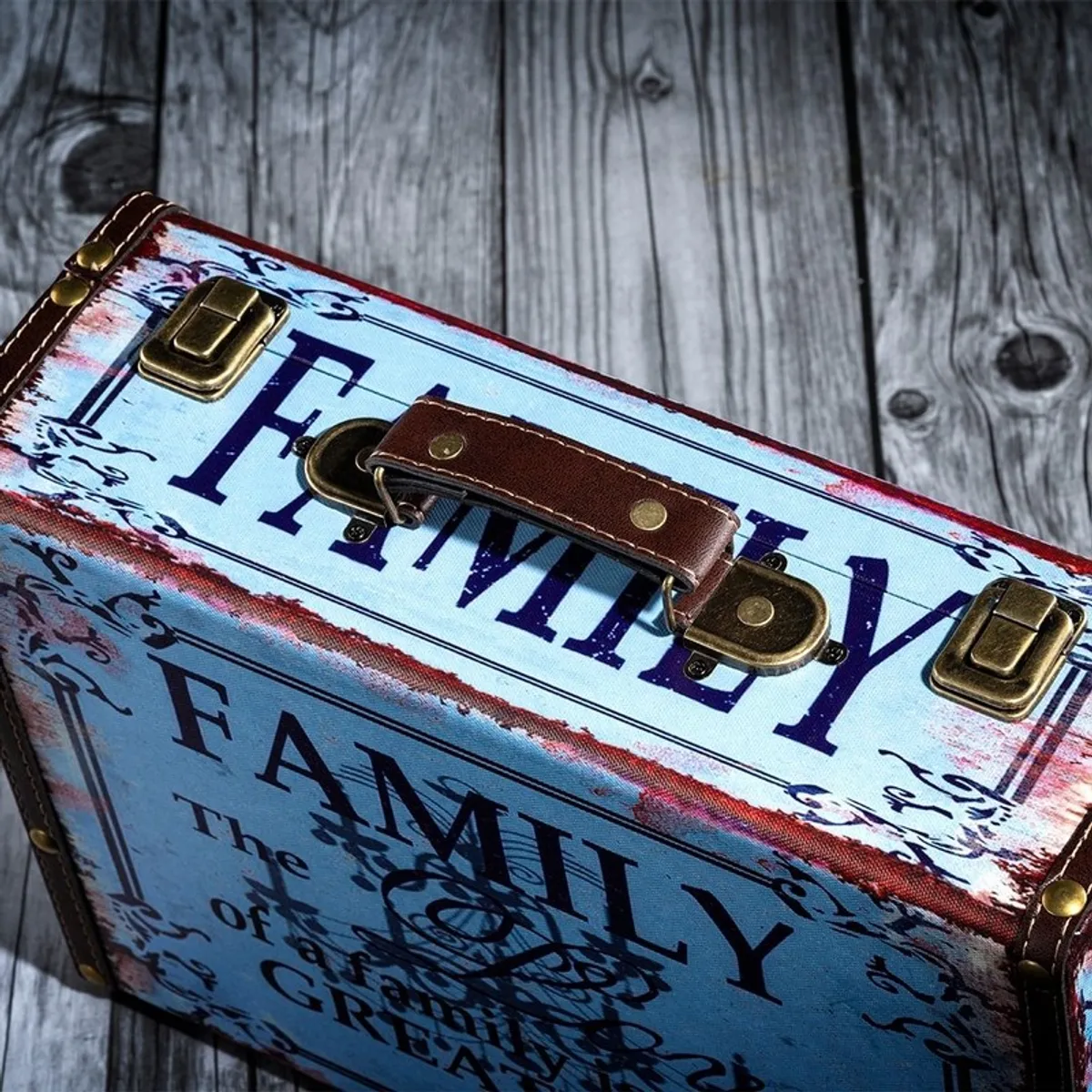 Close-up of blue canvas storage box with family lettering, handle and metal latches