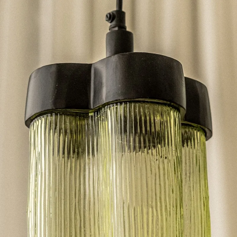 Close-up of ribbed green glass shade and black top detail