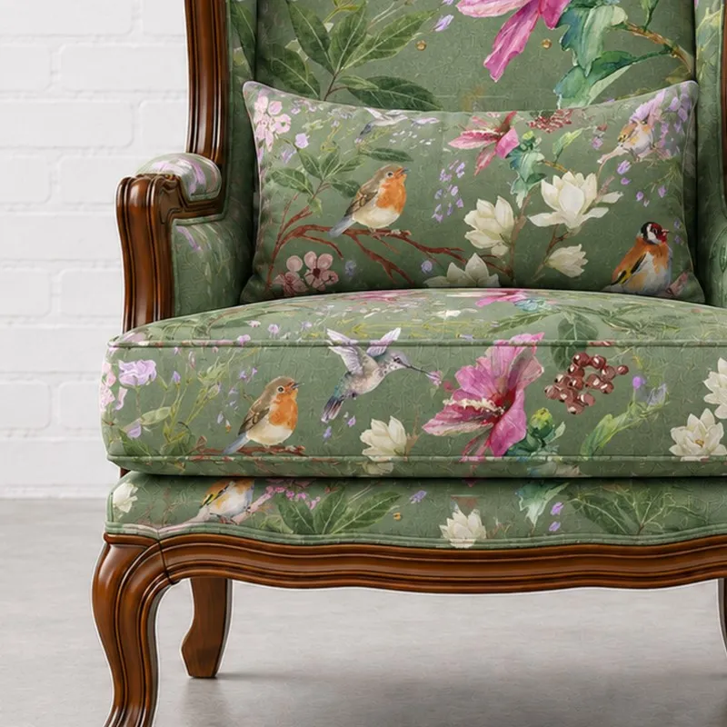 Close-up of floral bird print upholstery and wooden base on lounge chair