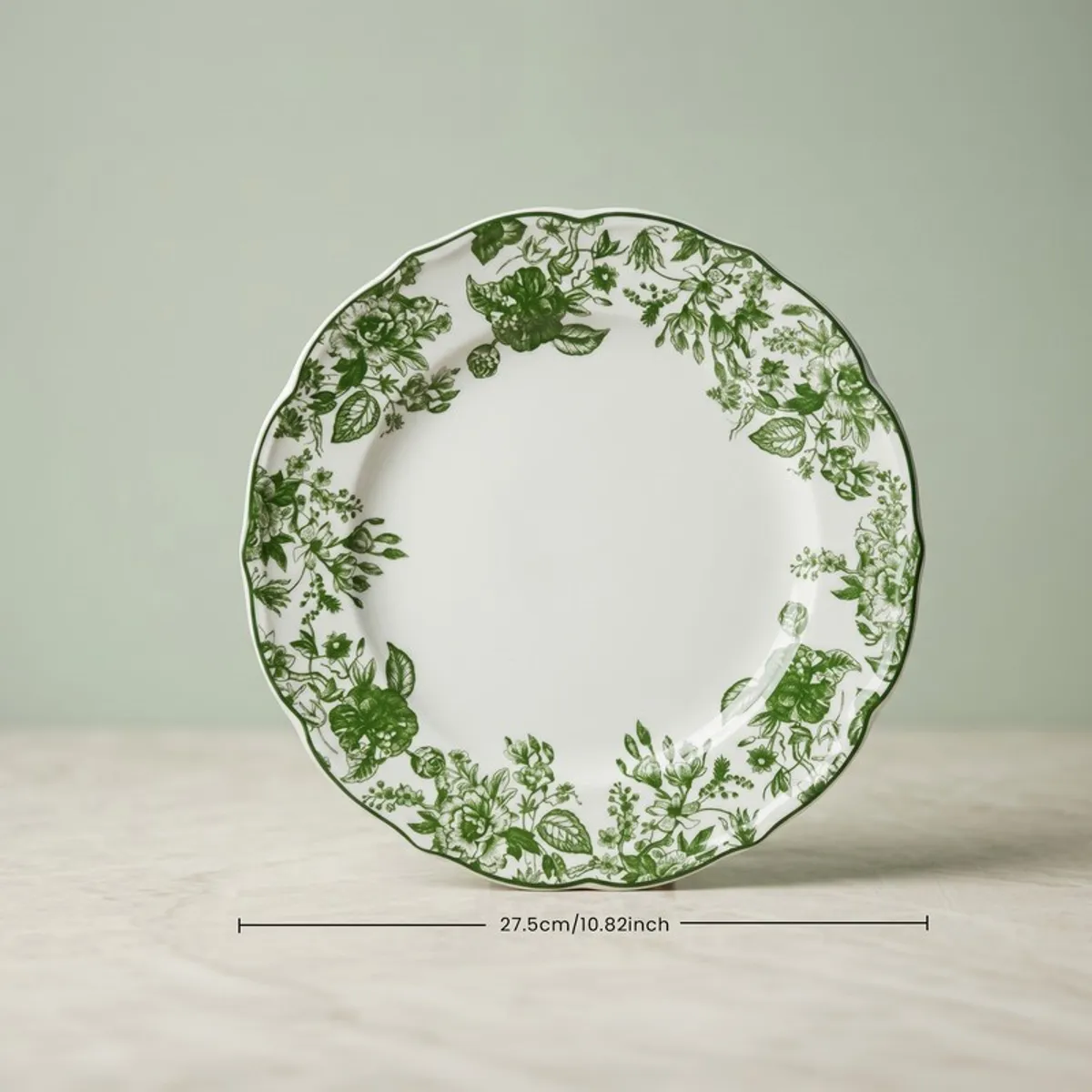 Single glossy dinner plate with green floral detailing and scalloped rim