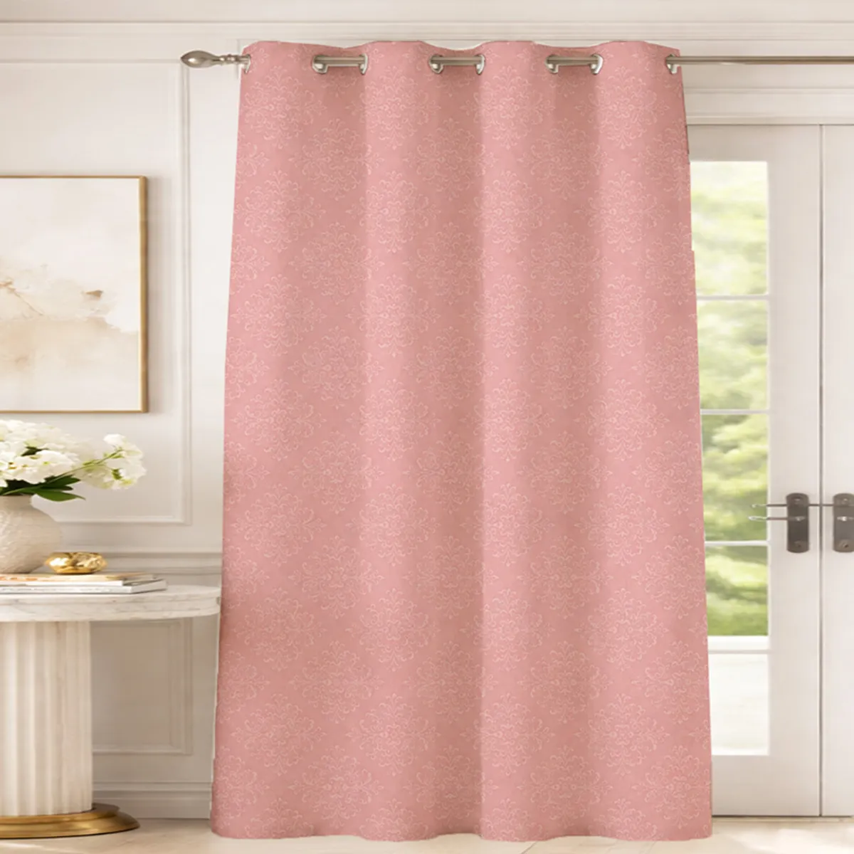 Pink patterned curtain hanging across a bright glass door with eyelet rings