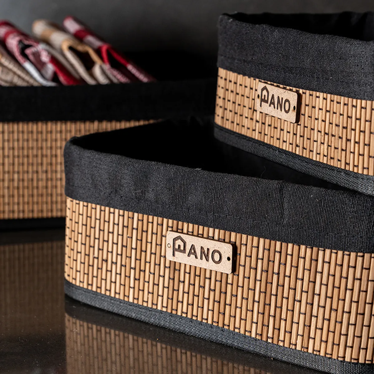 Close-up of black and natural woven rectangular storage baskets