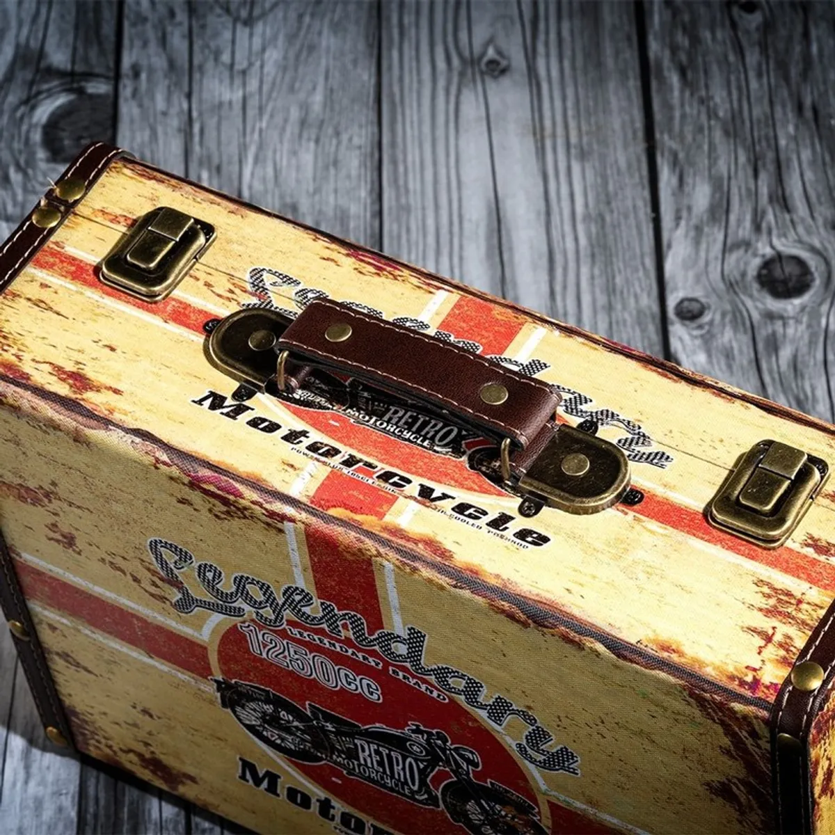 Close-up of the storage box handle, latches and distressed printed canvas surface