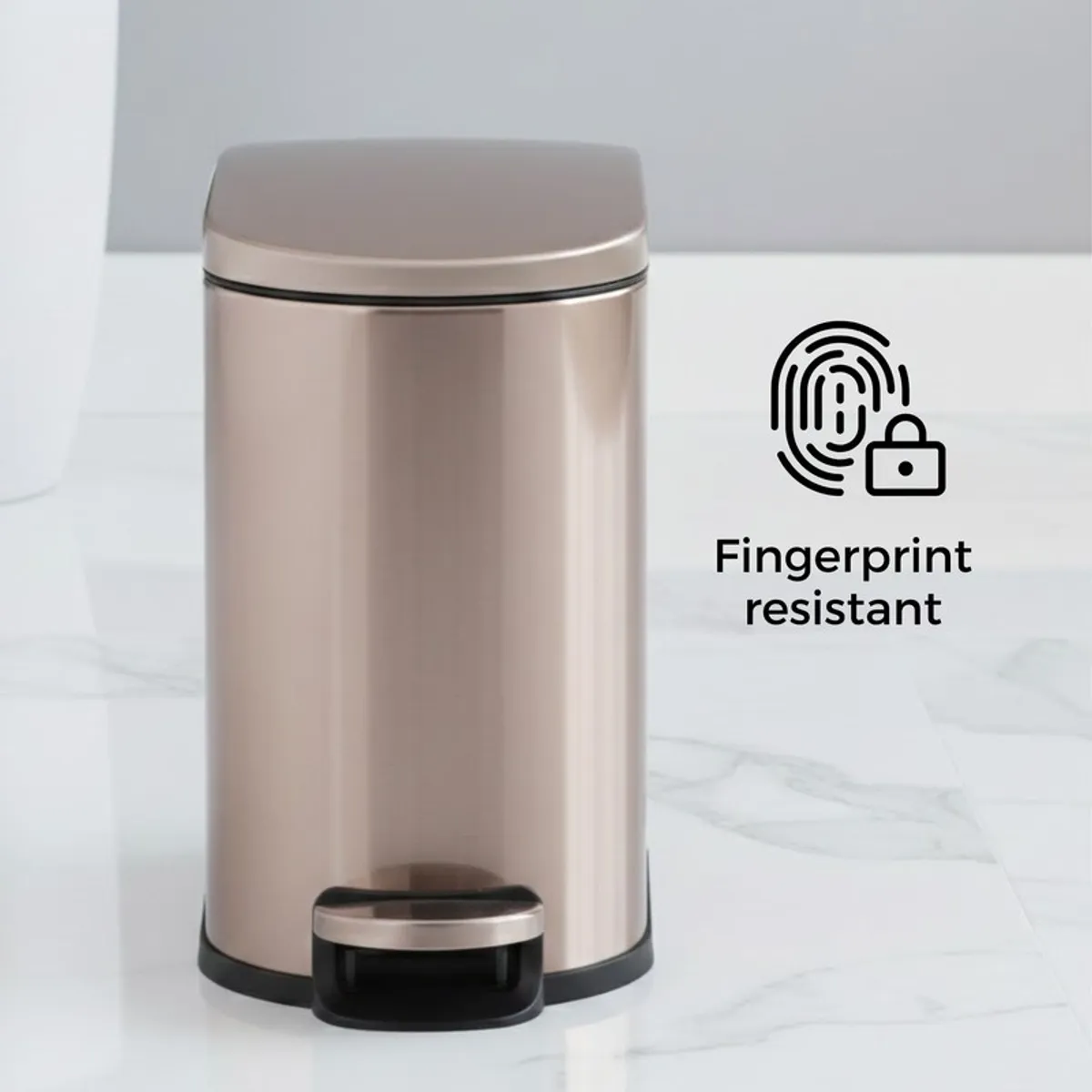 Front view of gold metal pedal dustbin with closed lid