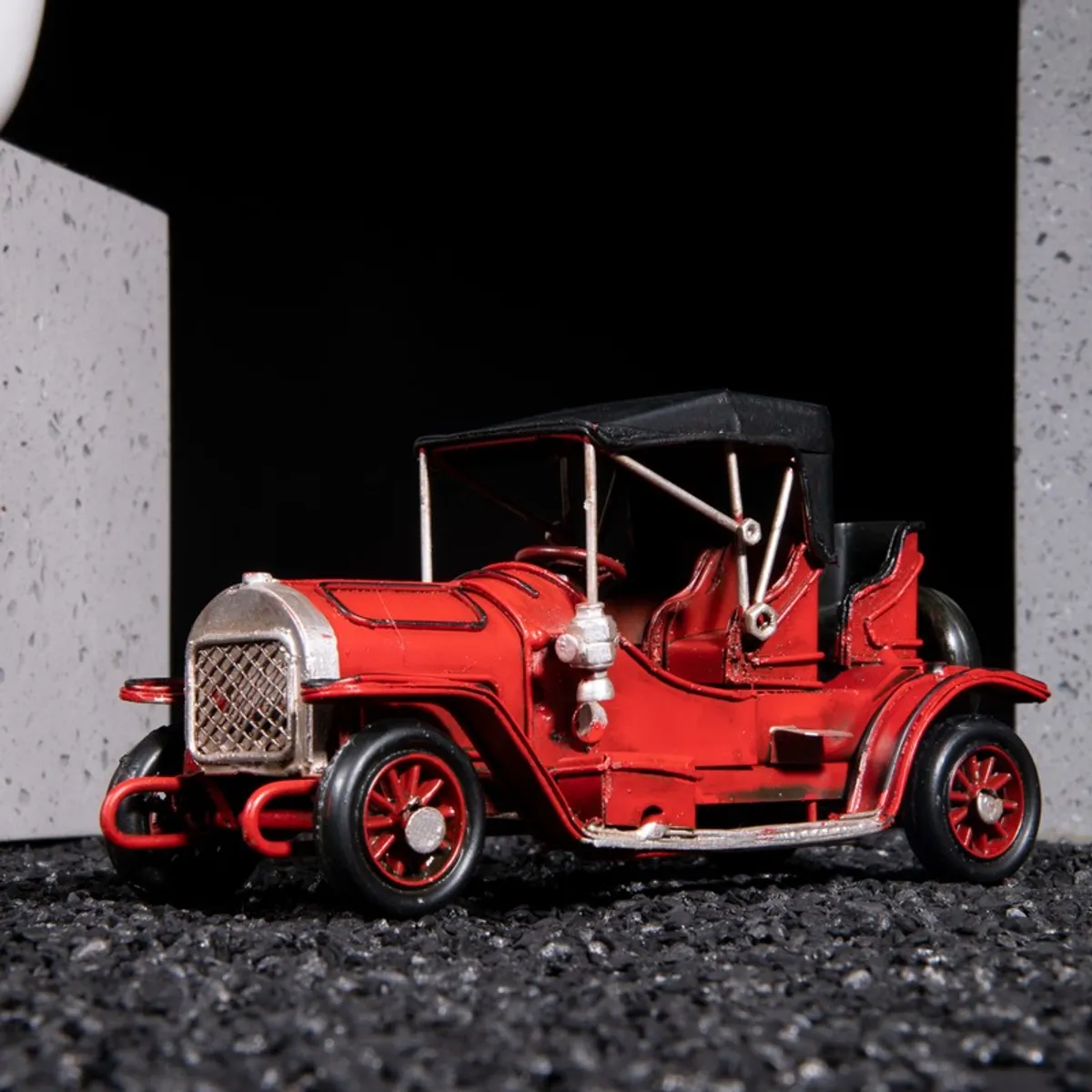 Side view of red vintage car showpiece with black roof