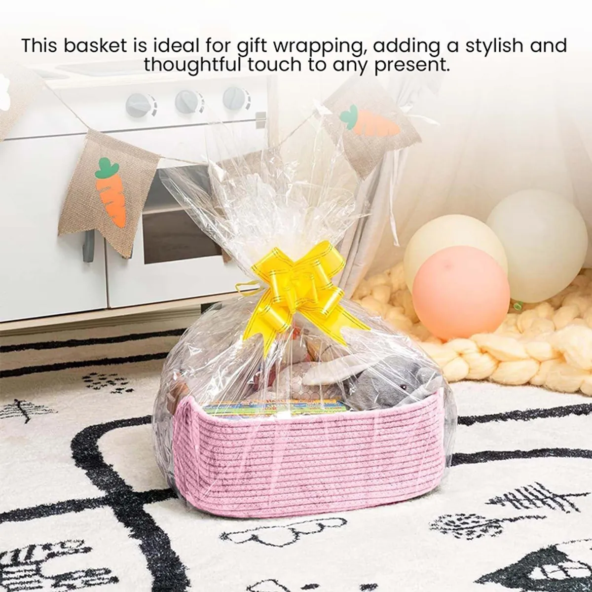 Pink woven basket styled as a gift hamper wrapped in clear cellophane