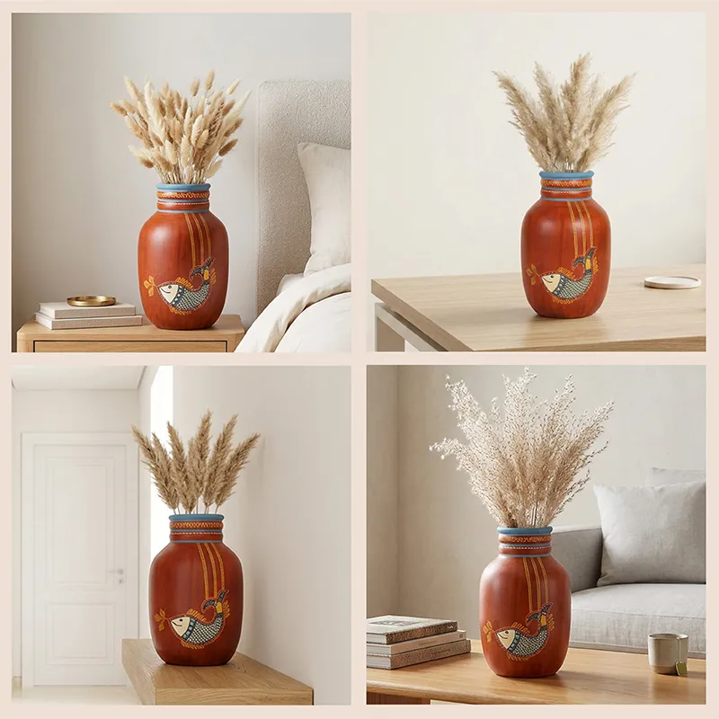 Four styled views of the red fish motif vase displayed with dried grass in indoor settings.