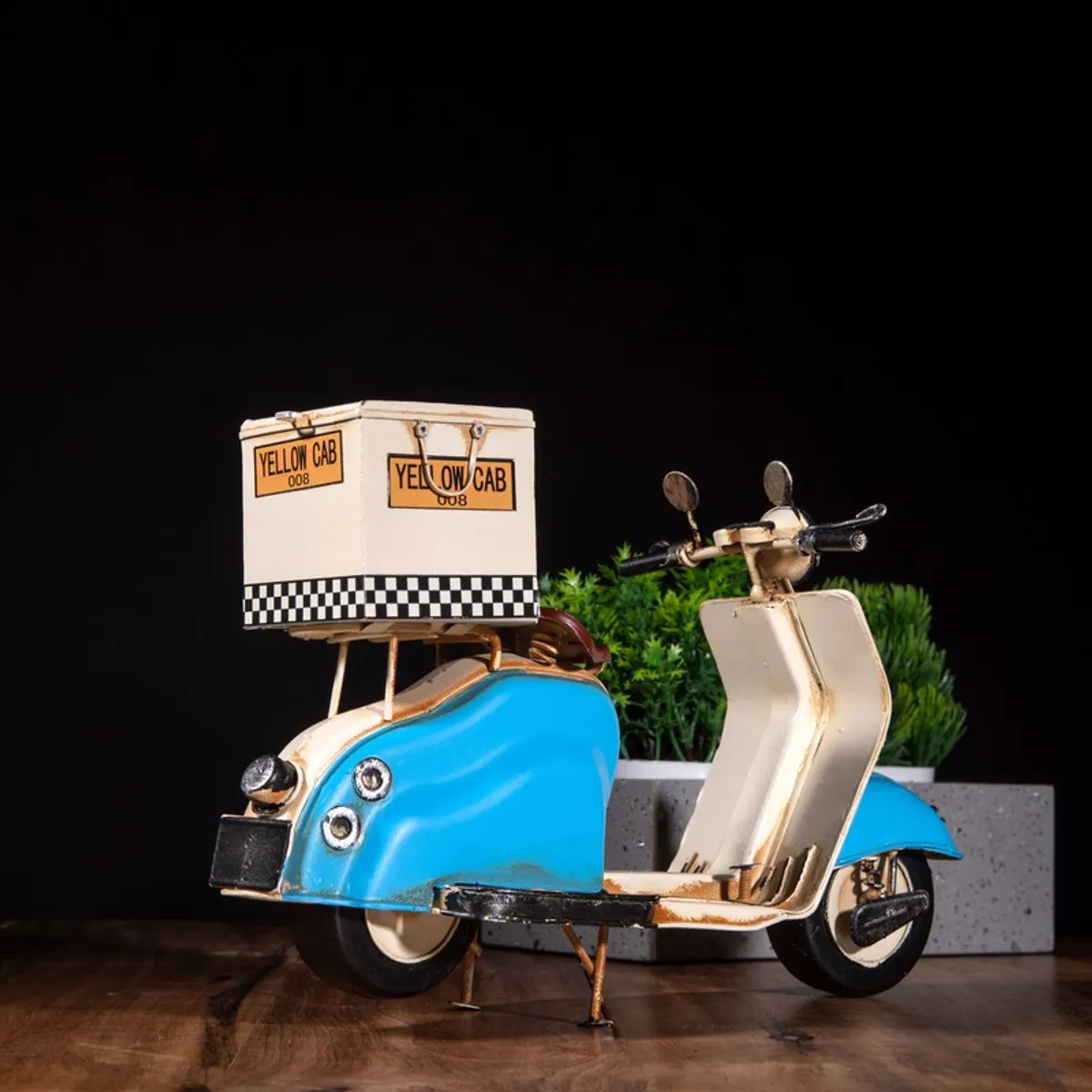 Rear angled view of vintage scooter showpiece in blue and cream
