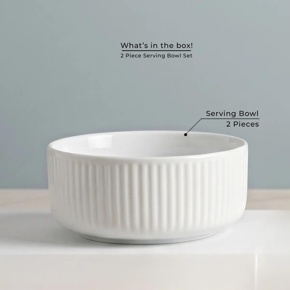 Single white round serving bowl with softly ribbed exterior