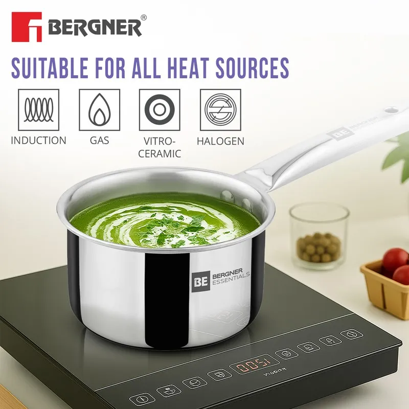 Silver saucepan with soup shown on an induction cooktop.