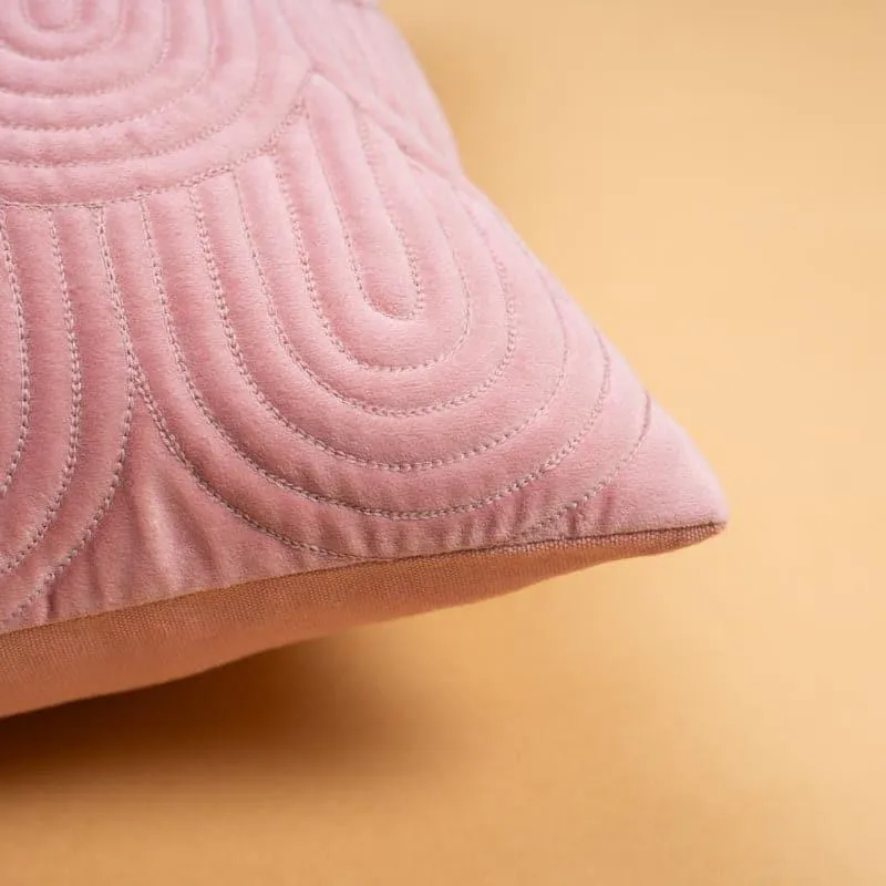 Close-up of the raised geometric pattern on a pink cushion cover