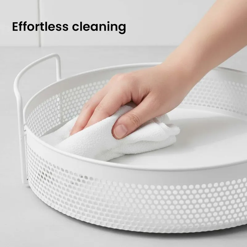 Close-up of a white round metal basket being wiped clean