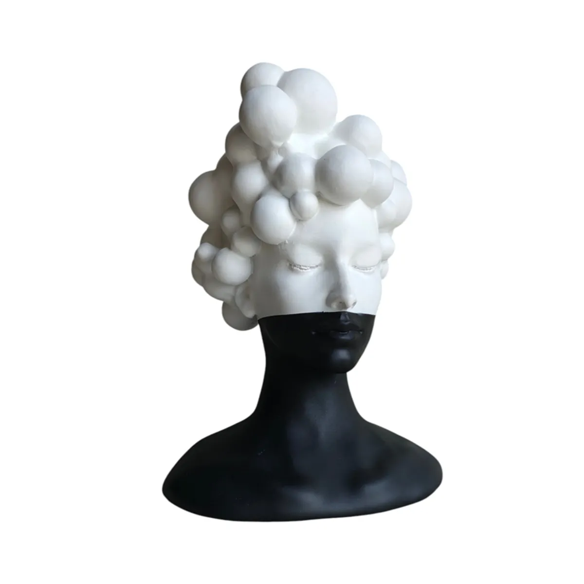 Front view of a monochrome female bust figurine with closed eyes and bubble-like hair