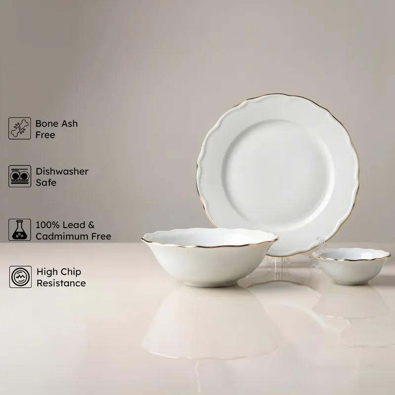 White porcelain plate and bowls with gold rim from the dinner set