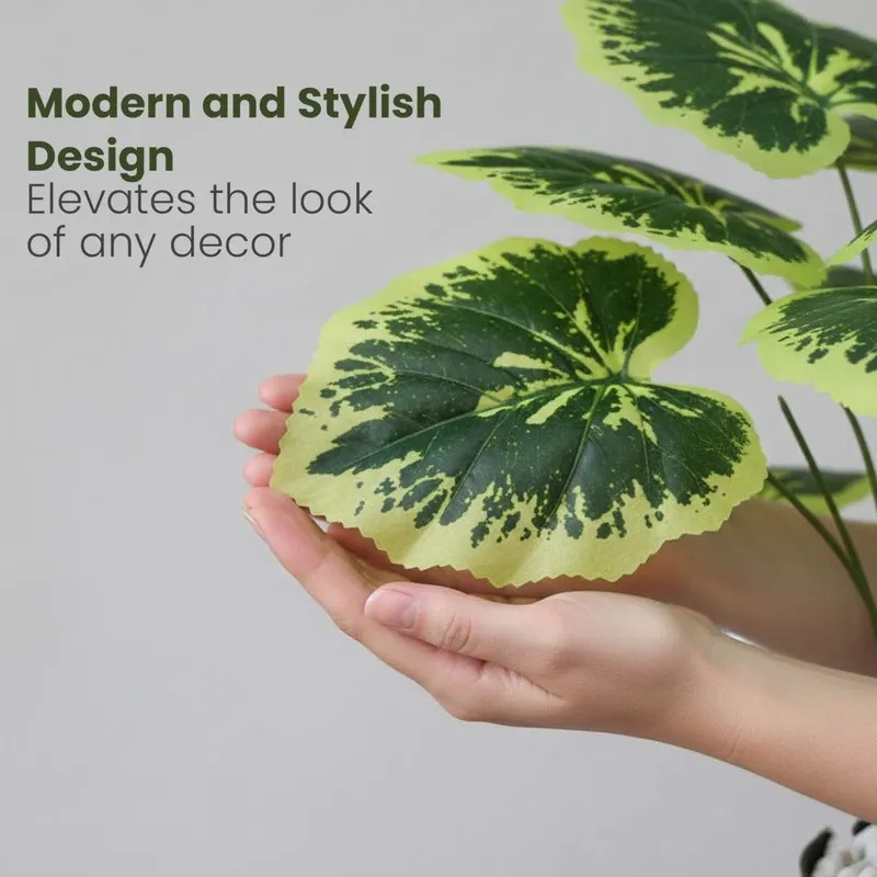 Close-up of a green and yellow patterned faux leaf held in hands.