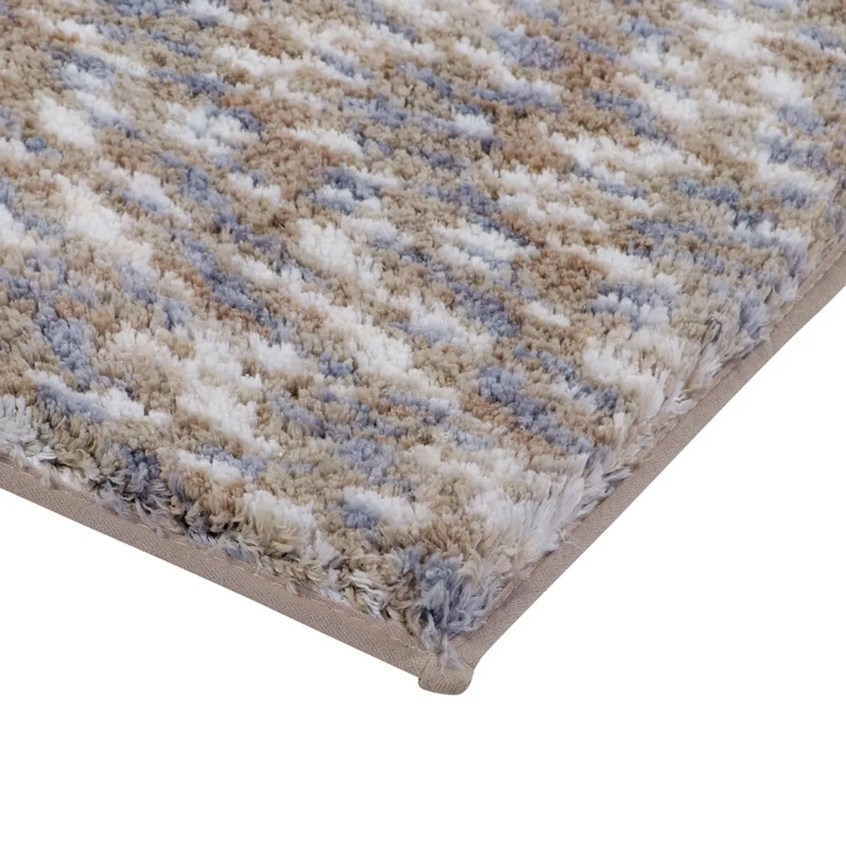 Close-up of the soft textured pile and beige edging on the bath mat