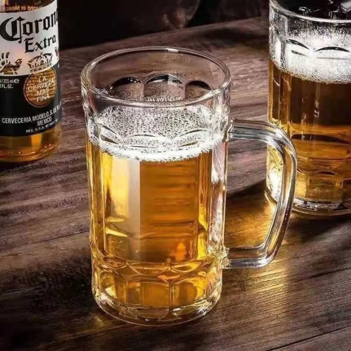 Clear beer mug filled with beer on a wooden table