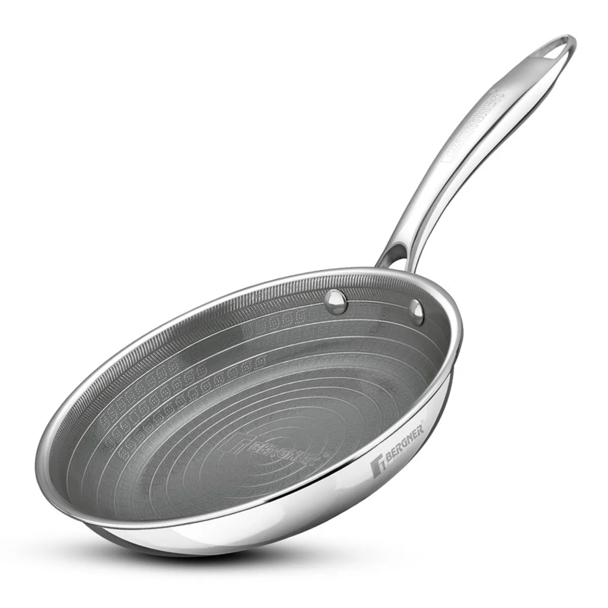 Silver triply frying pan shown at an angle on a white background