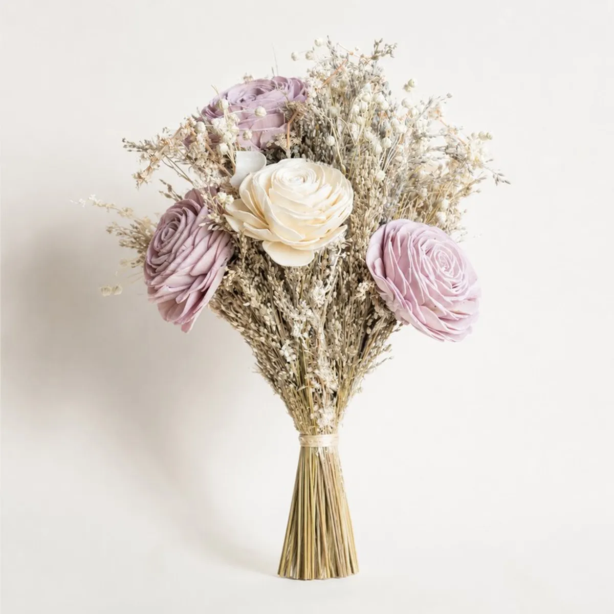 Close view of a lilac and off-white dried flower bunch tied at the stems