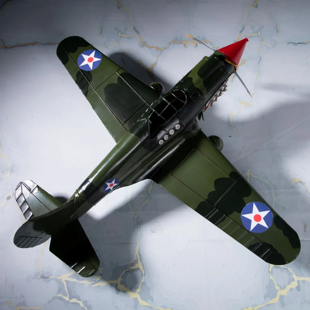 Top view of vintage aircraft showpiece in olive green with wing insignia