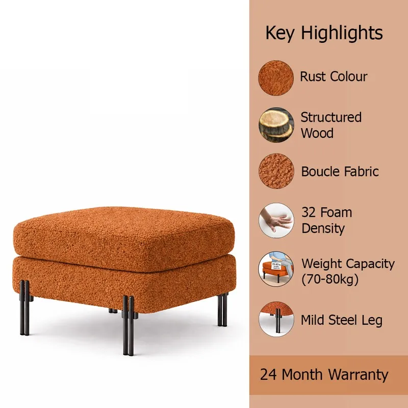 Rust bouclé ottoman shown with black legs against a white background