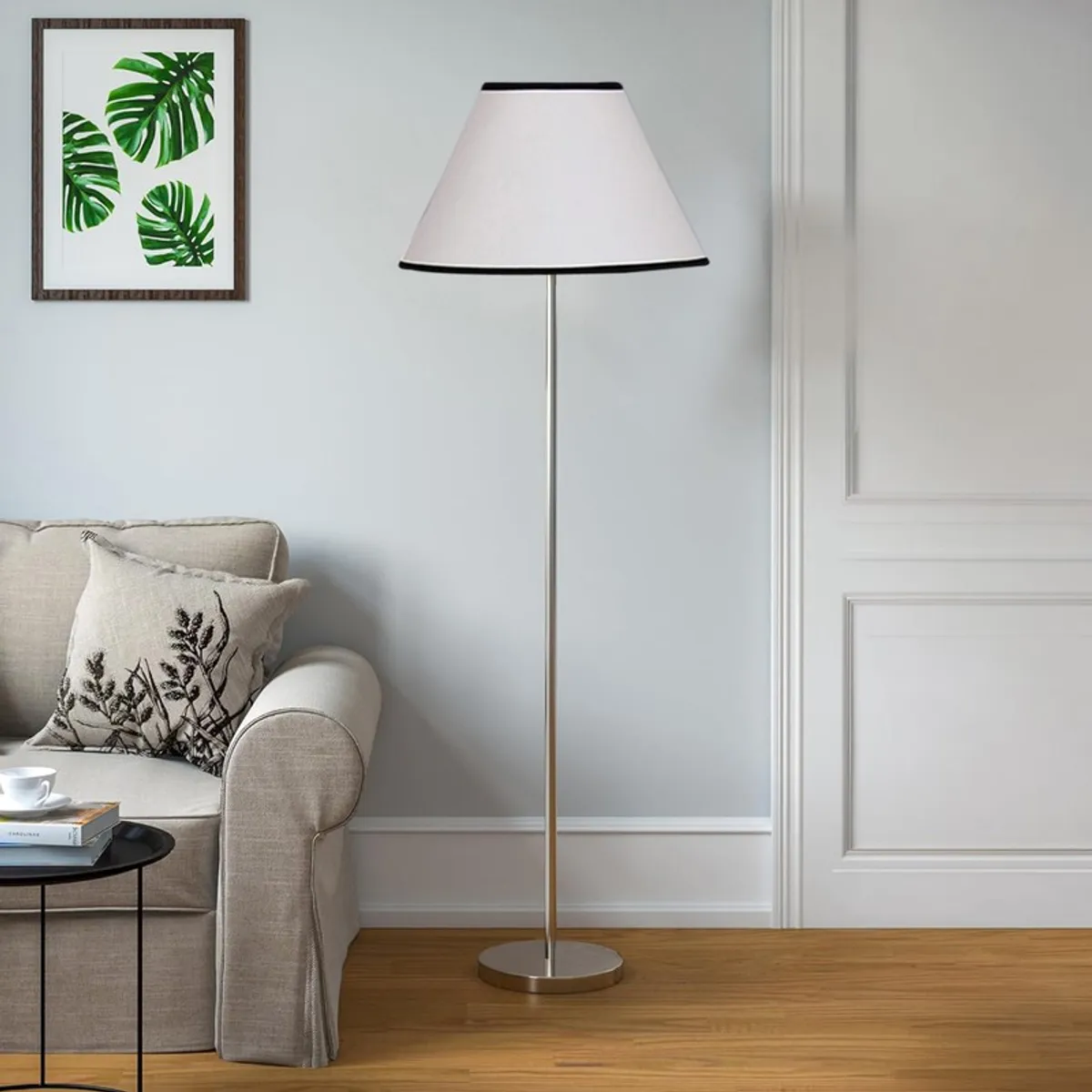 Ivory floor lamp with tapered shade in a bright living room corner