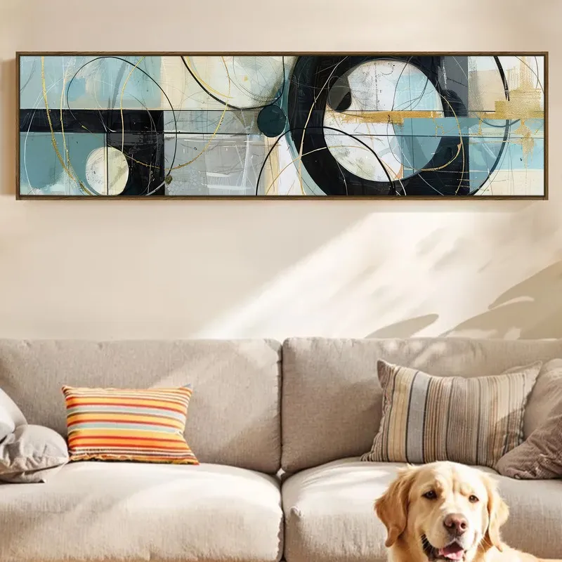 Panoramic abstract wall art in blue, black and gold above a beige sofa