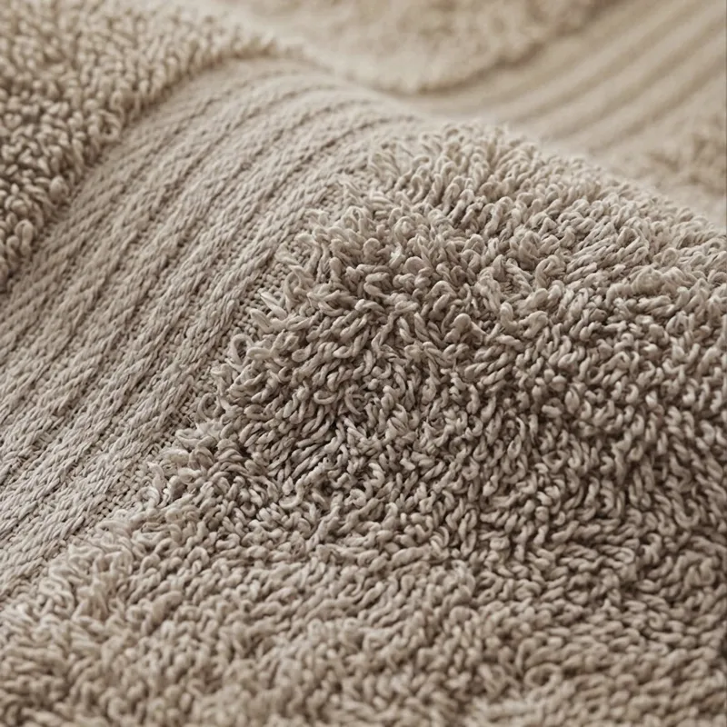 Close-up of the beige towel's plush textured cotton surface